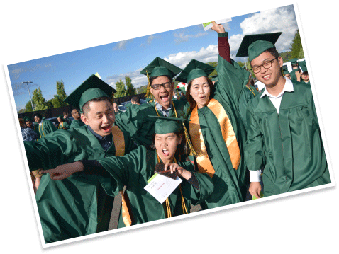 excited graduates posing in robes and caps